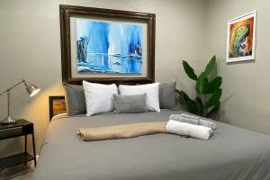 a bedroom with a bed with a painting on the wall at Artists Bungalow ARCADE King Beds near the beat in Sacramento