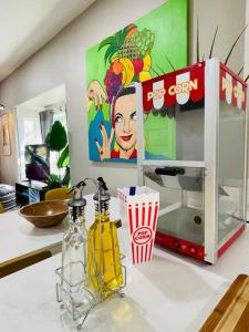 a microwave on a counter with two bottles of soda at Artists Bungalow ARCADE King Beds near the beat in Sacramento +15 photos