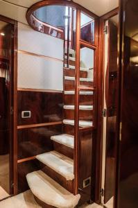 a wooden cabinet with stairs in a room at Super Yacht Located in Puerto Banus in Marbella