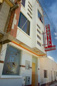 a hotel with a sign on the side of a building at HOSTAL SALARCITO in Uyuni