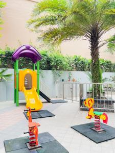 a childrens playground with a play area and a play structure at Sunshine 100 Stylish Condo by Homexperience in Manila