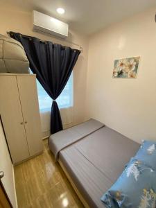 a small bedroom with a bed and a window at Palas Tiny Homestay in Changlun +20 photos