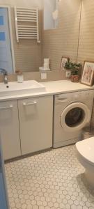 a bathroom with a washing machine and a toilet at Old Town Warsaw Joanna's Apartments in Warsaw +112 photos