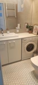 a bathroom with a washing machine and a toilet at Old Town Warsaw Joanna's Apartments in Warsaw