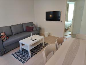 a living room with a couch and a table at Aalborg City Rooms ApS in Aalborg