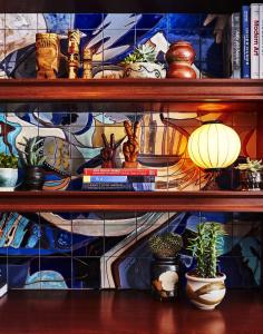 a shelf with potted plants and books on it at Freehand Chicago in Chicago