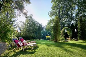 two chairs sitting on a lawn in a yard at Hotel Schloss Mittersill in Mittersill