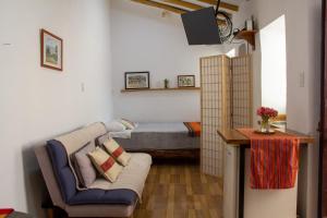 a bedroom with a couch and a bed in a room at Santo Domingo in Ayacucho