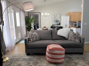 a living room with a couch and a kitchen at Mimosa Place Newly remodeled in 2023 in Rogers