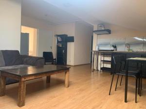 a living room with a couch and a table at Perlos Apartamentai 14 in Birštonas