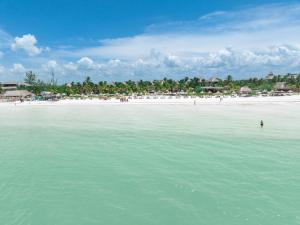 a view of a beach with people in the water at Blue Holbox in Holbox Island