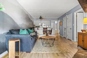 a living room with a blue couch and a table at VIEWS & POOL - Minutes to Gburg and Ober - Condo in Gatlinburg