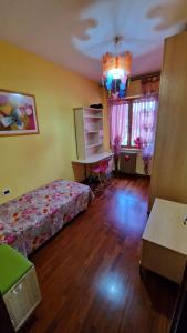a bedroom with a bed and a desk in it at La casa di Luca in Abbadia San Salvatore