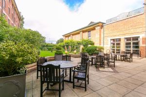 a patio with tables and chairs on a patio at Cedar Court Bradford Hotel in Bradford