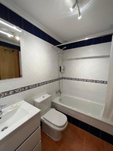 a bathroom with a toilet and a sink and a tub at Estrella de O Vicedo in O Vicedo +34 photos