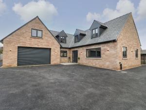 a large brick house with a garage at Farley Meadow View in Matlock