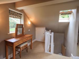 a home office with a desk and a window at Dove Tail Barn in Underbarrow
