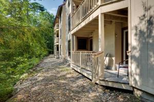 a porch of a house with a balcony at Riverfront Lincoln Condo with Pool Mins to Loon Mtn in Lincoln