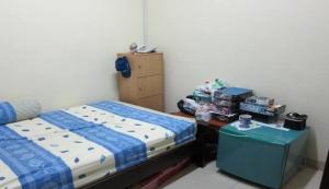 a bedroom with a bed and a table with boxes at Dulcon278 in Sukarami +1 photo