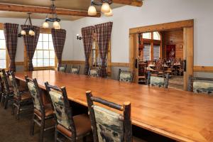 a dining room with a large wooden table and chairs at Hilton Garden Inn Missoula in Missoula +46 photos