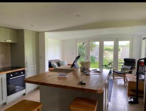 a kitchen with a table with a laptop on it at Littlewood Cabin in Hatherleigh