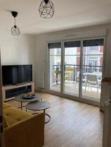 a living room with a couch and a tv at Very nice 40m quiet with parking space in Suresnes