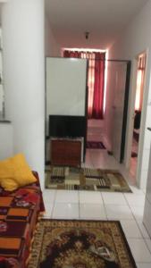 a living room with a couch and a flat screen tv at Apartamento Pelourinho in Salvador