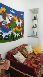 a bedroom with a bed and a painting on the wall at Apartamento Pelourinho in Salvador