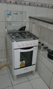a white stove top oven sitting in a kitchen at Apartamento Pelourinho in Salvador