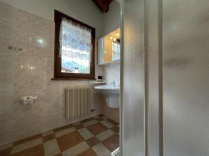 a bathroom with a sink and a toilet and a window at 032 Mansarda Pinzolo in Pinzolo +21 photos