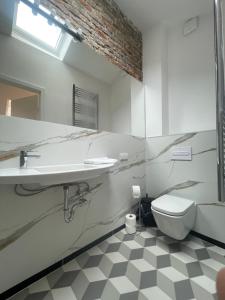 a bathroom with a sink and a toilet at Florianska Deluxe Apartments with Air Condition in Krakow