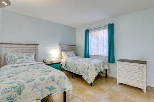 a bedroom with two beds and a window at Okaloosa Island Condo Near Boardwalk and Beach! in Fort Walton Beach