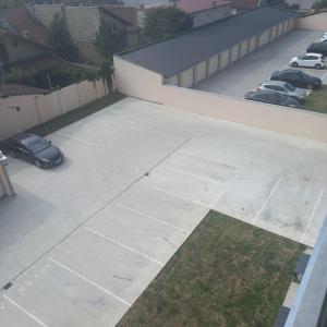 a parking lot with a car parked next to a building at Apartman Prodan in Sombor