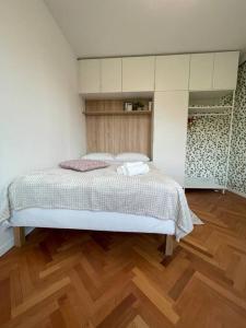a bed in a room with a wooden floor at Studio with a view on City center park in Maribor