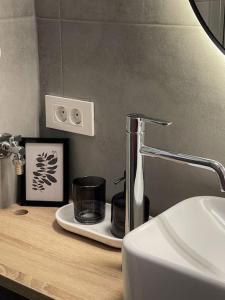 a bathroom with a sink and a counter with a cup at Studio with a view on City center park in Maribor