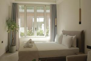 Postel nebo postele na pokoji v ubytování Living Stone Condo Hotel