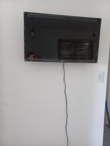 a television on top of a white refrigerator at El Pericon y Belgrano in Punta Indio