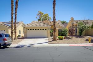 a house with palm trees in front of a driveway at North Las Vegas Home about 5 Mi to Fremont St! in Las Vegas