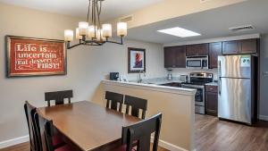 a kitchen with a table and a kitchen with a refrigerator at Bluegreen Vacations Suites at Hershey in Hershey