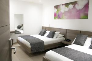 Ένα ή περισσότερα κρεβάτια σε δωμάτιο στο BGA Hotel