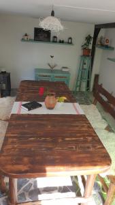 a large wooden table in a living room with a table at Facilitati cazare Raluca in Viscri