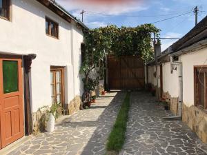 an alley in a house with a wooden gate at Facilitati cazare Raluca in Viscri +16 photos