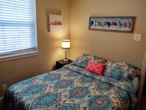 1 dormitorio con 1 cama con una manta colorida y una lámpara en Spacious Lakeside Country Getaway! en Hot Springs