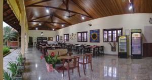a restaurant with tables and chairs in a building at Pousada do Sol in Brotas