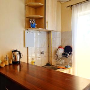 a kitchen with a wooden counter top and a sink at Crystal Cribs Eldoret in Eldoret