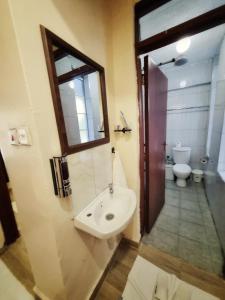 a bathroom with a sink and a toilet at Crystal Cribs Eldoret in Eldoret