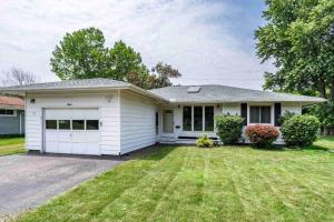 a white house with a garage at Enjoyable Home by Airport & Dwtn in Rochester