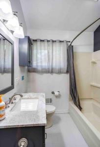 a small bathroom with a sink and a toilet at Enjoyable Home by Airport & Dwtn in Rochester