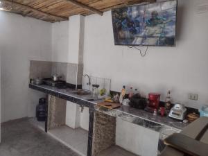 a kitchen with a counter in a room at Nomads Club in Nazca
