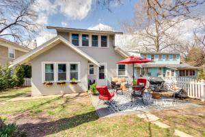 a white house with a patio with red chairs at Charming Kansas City Cottage 5 Mi to Downtown in Kansas City